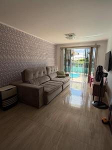 a large living room with a couch and a television at Casa em Ipanema - Pontal do Paraná in Pontal do Paraná
