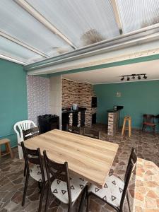 a wooden table and chairs in a room at Casa em Ipanema - Pontal do Paraná in Pontal do Paraná