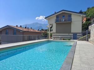 a swimming pool in front of a house at Immobillario - Lakes Dream in Domaso