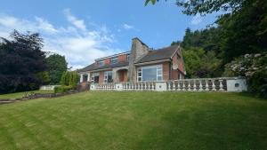 a large house with a fence in a yard at Tullyeskar House - Monasterboice in Philipstown