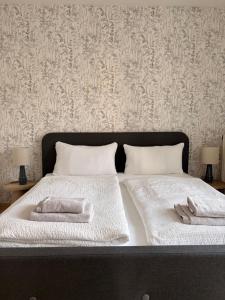 a bedroom with a bed with two towels on it at BrunnenApart Nova in Bad Oeynhausen
