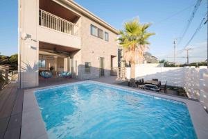 a swimming pool in front of a house at THE POOL HOUSE Kisarazu in Kisarazu