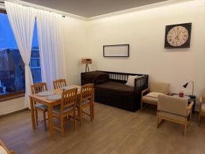 a living room with a couch and a table and chairs at Dům mezi loukami in Sněžné