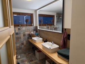 a bathroom with two sinks and a large mirror at Dům mezi loukami in Sněžné +16 photos