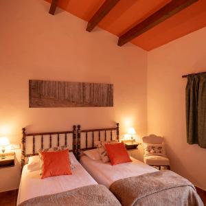 a bedroom with two beds and two tables and chairs at Casatona in San Mateo de Bages