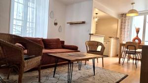 a living room with a couch and chairs and a table at Le Saint Jacques - Downtown in Melun