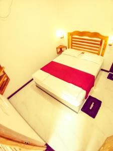 a bedroom with a large bed with a red blanket at Diamond Resorts in Udawalawe +50 photos