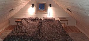 a room with two beds in a attic at Fully equipped cottage near the sea in Rockneby