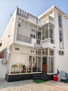 a large white house with large windows at Sri Ram Shankar-Saryu Ghat in Ayodhya