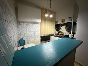 a kitchen with a blue counter top in a room at Kara Apartaments in Ploieşti