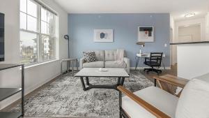 a living room with a couch and a table at Landing Apartments - Prospect Hall in Frederick