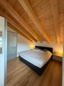a bedroom with a large bed and wooden ceilings at Haus Lagger in Seefeld in Tirol