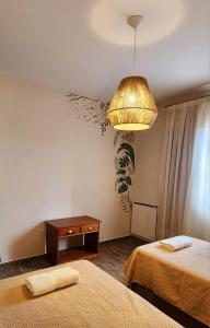 a bedroom with two beds and a lamp and a table at Las Cabras Complejo Turístico in Potrero de los Funes