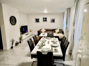 a dining room with a table and chairs and a couch at Rio Home in Büsingen