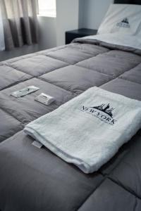 a bed with a white towel on top of it at Hostal New York in Jauja +10 photos