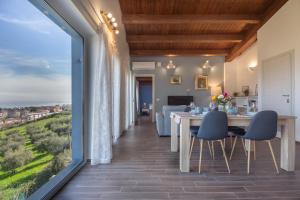 a dining room with a table and chairs and a large window at B&B Villamarea in Francavilla al Mare