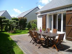 a wooden table and chairs on a patio at Chambre lit double in Saint-Herblain