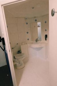 a bathroom with a toilet and a sink at Quick Palace Saint Brieuc in Tregueux +30 photos