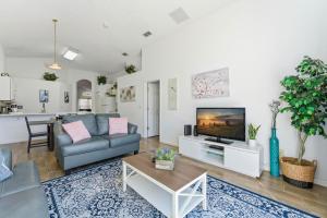 a living room with a couch and a tv at 4 BR No carpet Just Remodeled Unit SR1205 in Kissimmee