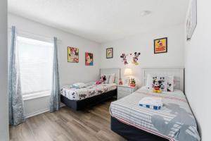 a bedroom with two beds and a window at 4 BR No carpet Just Remodeled Unit SR1205 in Kissimmee