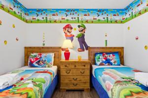 two beds in a childs bedroom with a disney mural at 4 BR No carpet Just Remodeled Unit SR1205 in Kissimmee