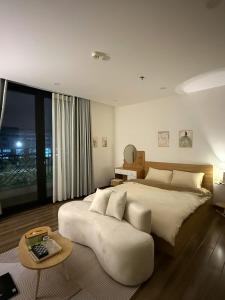 a bedroom with a large bed and a large window at LucyHouse in Thôn Trường Giang
