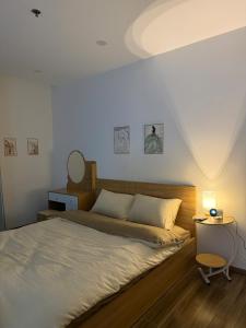 a bedroom with a bed and a table and a mirror at LucyHouse in Thôn Trường Giang