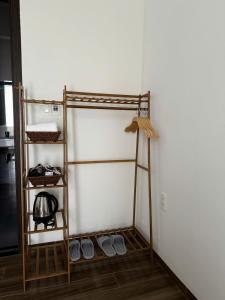 a room with a ladder next to a wall at LucyHouse in Thôn Trường Giang