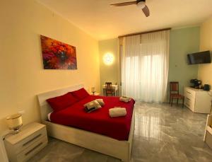 a bedroom with a bed with red pillows at Villa Silvana in Perledo