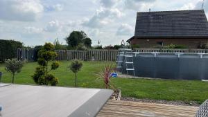 a backyard with a slide in a yard with a house at Guedon sandrine in Grosley-sur-Risle