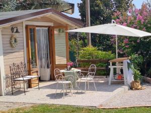 a patio with a table and an umbrella at A un passo dal Collio in Mossa