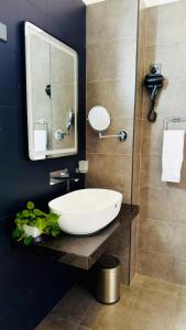 a bathroom with a white sink and a mirror at Humble Ella in Ella