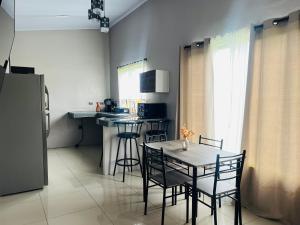 a small kitchen with a table and chairs in a room at Epic Arenal View House in Fortuna