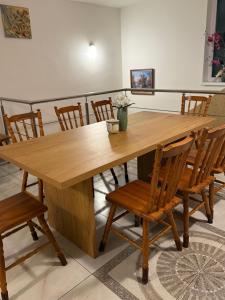 a wooden table with chairs and a large wooden table at Chata Zemplin in Kaluža