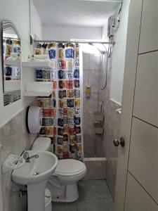 a bathroom with a toilet and a sink and a shower at Kaihalulu Beach Room - Punta Hermosa in Punta Hermosa +24 photos