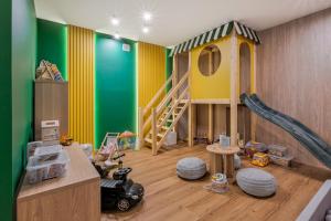 a childs play room with a slide and a playground at Apartamenty 3 Owce z widokiem na Giewont in Kościelisko