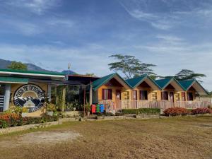 a row of cottages with a sign in front at Casa de Descanso in Kiawagan