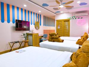 a room with two beds with a teddy bear on them at Casa de Capybara in Siem Reap