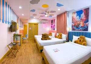 a room with two beds with teddy bears on them at Casa de Capybara in Siem Reap +56 photos
