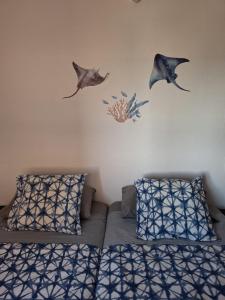 a bedroom with a bed and fish decals on the wall at Candela's Beach Port in El Masnou