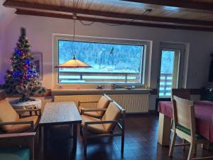 a living room with a christmas tree and a table at House Nordika in Rateče