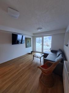 a living room with a couch and a table at House Nordika in Rateče
