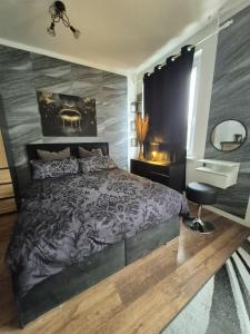 a bedroom with a large bed and a mirror at Onyx Urban Suite in Hannover +6 photos
