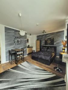 a bedroom with a bed and a table in it at Onyx Urban Suite in Hannover