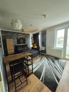 a living room with a couch and a table at Onyx Urban Suite in Hannover