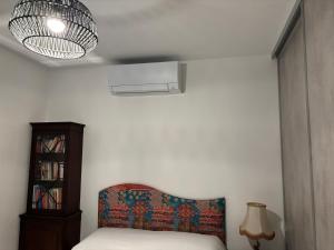 a bedroom with a bed and a lamp and a chair at La perle in Les Mathes +25 photos