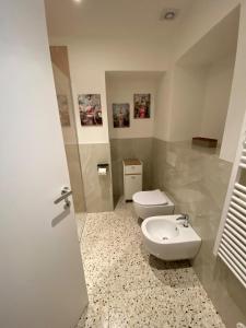 a bathroom with a toilet and a sink at Casa MELISSA LIMONCELLA , free parking-self check in in Tavernerio