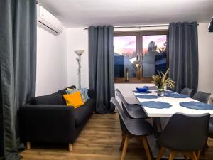 a living room with a table and a couch at SAN ESCOBAR sauna jacuzzi jezioro in Rogowo +20 photos