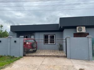 a house with a gate in front of it at Casa Gui in São Gabriel
