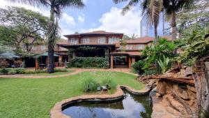 a house with a pond in the yard at Fairview Hotel Nairobi, Vignette Collection by IHG in Nairobi
